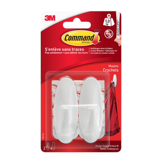 Eine Verkaufspackung Command™ Medium Designer-Haken, 17081-FGN der 3M Deutschland GmbH enthält zwei weiße Haken und Klebestreifen in einer Blisterpackung - ideal für die organisierte Aufbewahrung und Ordnung zu Hause.