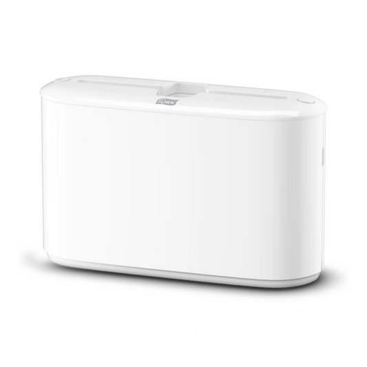 Ein weißes, rechteckiges elektronisches Gerät mit glatten Kanten und einer flachen Oberseite mit einem zentralen Schlitz, das den eleganten Stil des Tork Xpress® 552200 Tischspender für Multifold-Handtücher Elevation H2 von TORK – Essity Professional Hygiene Germany GmbH widerspiegelt.