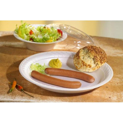 A paper plate with two sausages, mustard, salad, and a roll. In the background, there is a salad bowl with the Starpak 50 dome lid, R-PET round Ø 15.5 cm · 2.5 cm clear | shrink wrap (50 pieces) and three small chili peppers on the table.