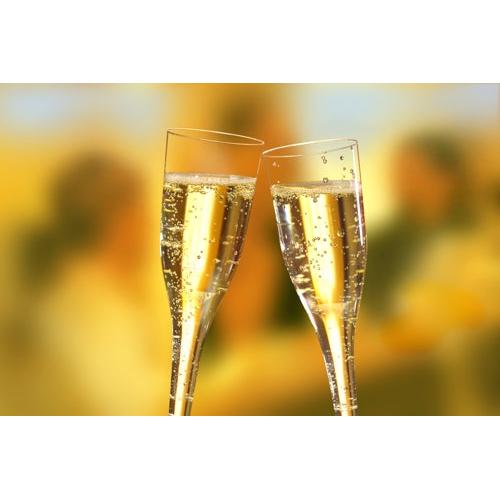 Two Starpak 10 stem glasses for champagne, PS 0.1l clink together, emphasizing true champagne enjoyment amidst a blurred scene of people and warm lights.