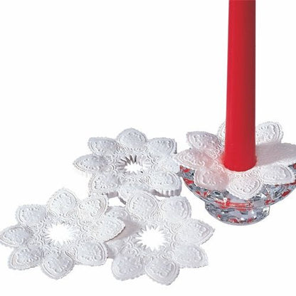 Three round, white PAPSTAR candle cuffs (Ø 10 cm, foil) can be seen: one wrapped around a red taper candle in a glass holder, two lying down - showcasing their elegant and decorative design from PAPSTAR GmbH.