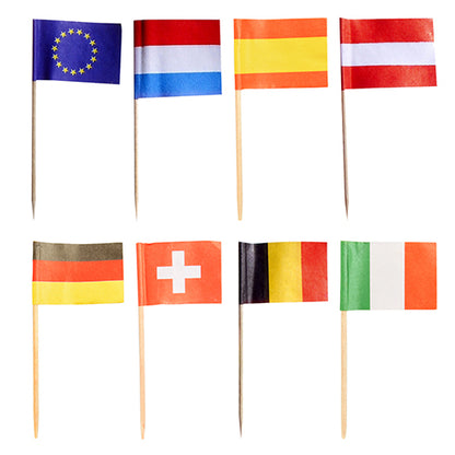 Fifty PAPSTAR decoration picks 8 cm "Nations" paper flags on wooden sticks (by PAPSTAR GmbH) are shown in two rows as stylish table decoration, featuring the countries EU, Netherlands, Spain, Austria, Germany, Switzerland, Belgium & Ireland. White background.