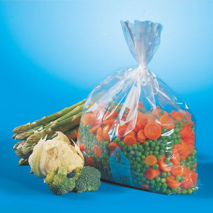 A transparent Starpak 24 freezer bag (LLDPE, 10 l, 60 x 40 cm) contains frozen mixed vegetables - mainly carrots and peas - in front of asparagus, cauliflower, and broccoli on a blue background. Ideal for food storage.