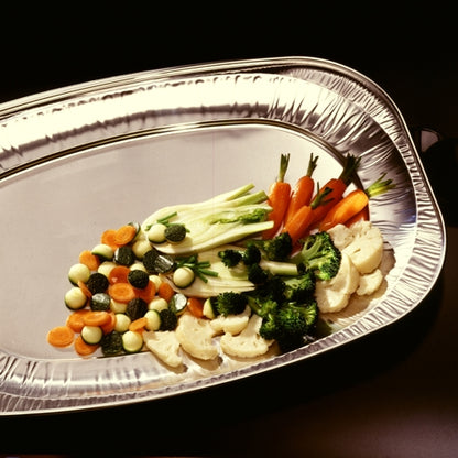 The Starpak 3 serving plates, aluminum from Starpak, are elegantly presented with steamed carrots, broccoli, zucchini, cauliflower, and onions neatly arranged in separate sections on a silver plate against a dark background.