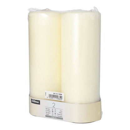 Two white Starpak 2 pillar candles Ø 80 mm with flat top, packaged in clear plastic with a beige label containing product details and barcode, add timeless elegance to any setting.