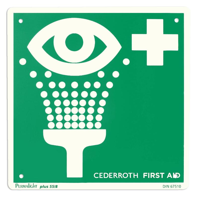 A green-white safety sign from Orkla Wound Care AB marks an "Emergency Sign - Eye Wash | Pack (1 piece)" station, showing an eye, a water jet, and a cross symbol, and guides to quick eye care with this essential emergency safety product.