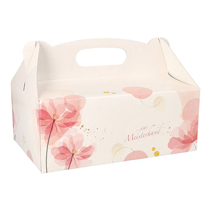 The PAPSTAR 15 pastry boxes from PAPSTAR GmbH are square, pink boxes with handles, decorated with floral patterns and golden dots - ideal for transporting baked goods. On the side is printed "From Master Hand".