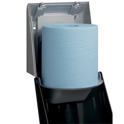 A close-up of a Kimberly-Clark Professional™ wiper dispenser - central pull / gray shows the open dispenser with a large blue roll, allowing for hygienic towel removal. By Kimberly-Clark GmbH.
