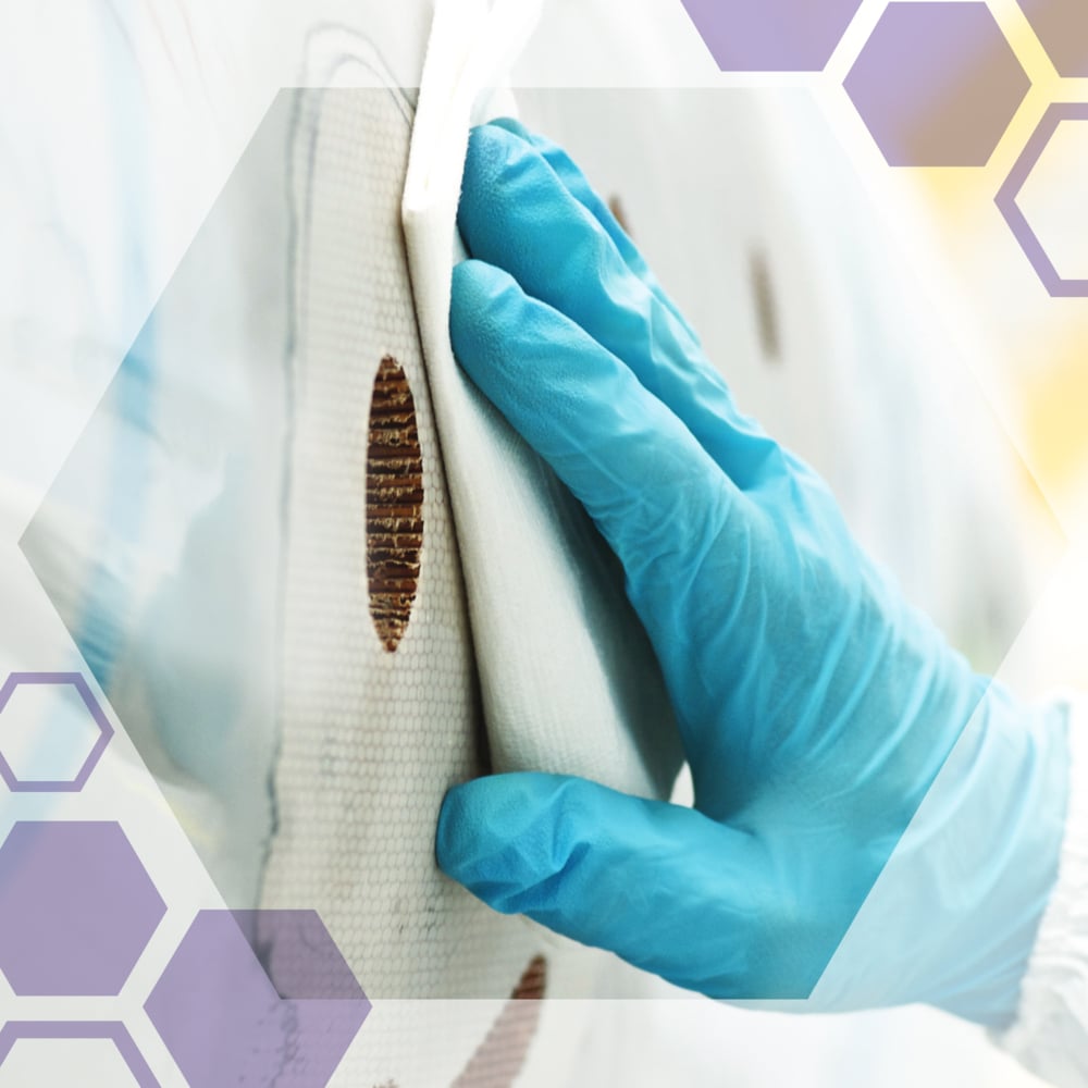 A gloved hand uses Kimtech® Science Precision Wipes from Kimberly-Clark GmbH (Pull Box/White/Large, 15x196 sheets) to clean a white object stained with brown circles. Hexagonal graphics overlay the image.