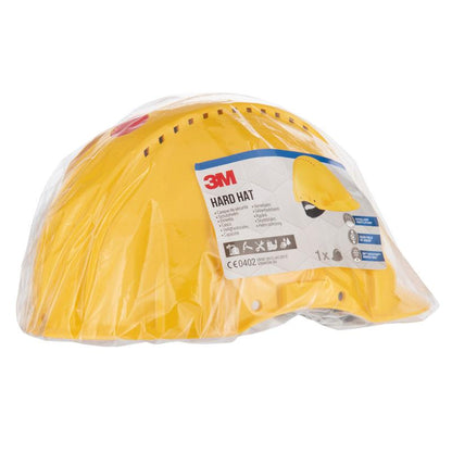 The yellow 3M™ Safety Helmet G3000C Uvicator from 3M Deutschland GmbH is delivered in a transparent plastic packaging with a product information label, safety symbols, a Uvicator sensor, and a small image of the safety helmet.