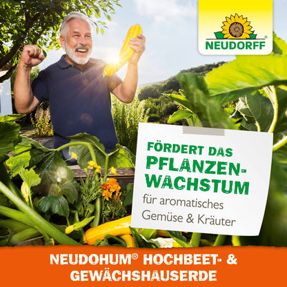 An older man smiles in a sunny garden holding a yellow zucchini amidst lushly thriving plants in a raised bed filled with NeudoHum Raised Bed & Greenhouse Soil from Neudorff Shop. A sign reads: "Promotes plant growth for aromatic vegetables & herbs."