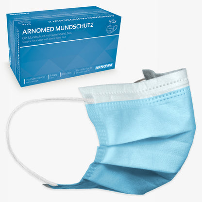 Hinter einer einzelnen hellblauen Einwegmaske mit weißen elastischen Ohrschlaufen steht eine blaue Schachtel mit der Aufschrift "ARNOMED MUNDSCHUTZ TYP IIR OP-Mundschutz mit Gummibändern Typ IIR" der ARNOWA GmbH, mit einer Maskenabbildung und deutschem Text.