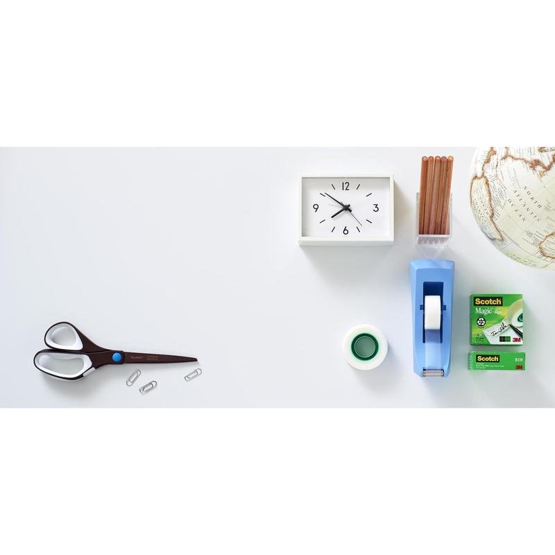 A Scotch™ titanium scissors (20 cm) from 3M Deutschland GmbH, three paper clips, a white clock, a pencil holder, a globe, a tape dispenser, and a box of Scotch tape are neatly arranged on a white surface.