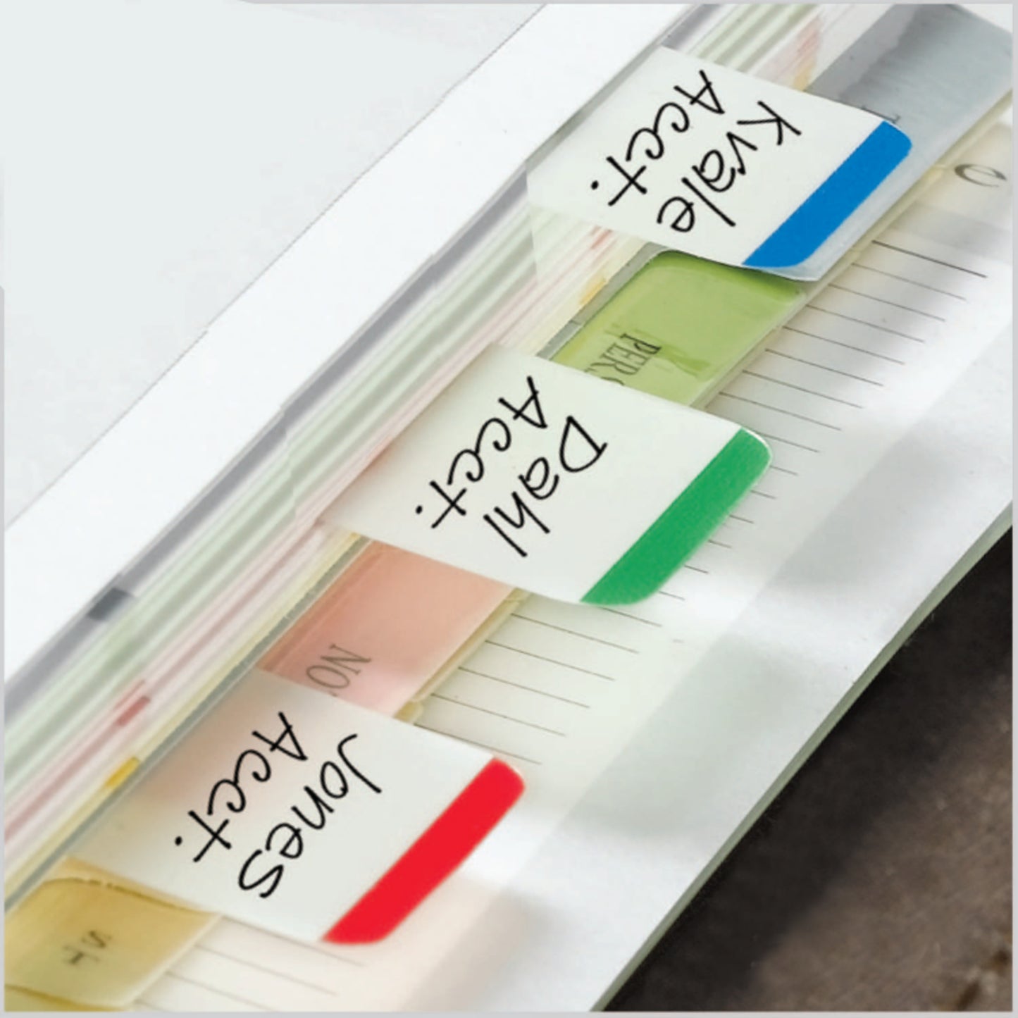 A close-up shows 3M Post-it® Index Strong Filing Tabs in various colors (25.4 mm x 38.1 mm) labeled "Jones Acct", "Dahl Acct", and "Kvale Acct" side by side in a folder. Each pack contains 66 index cards.