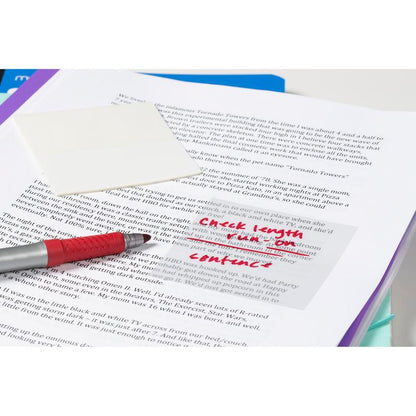 A red pen rests on an open book with handwritten notes on a Post-it® Transparent Note, 73 mm x 73 mm, from 3M Deutschland GmbH. The note reads: "Check length, work on style, continue." A blank sheet lies next to it.
