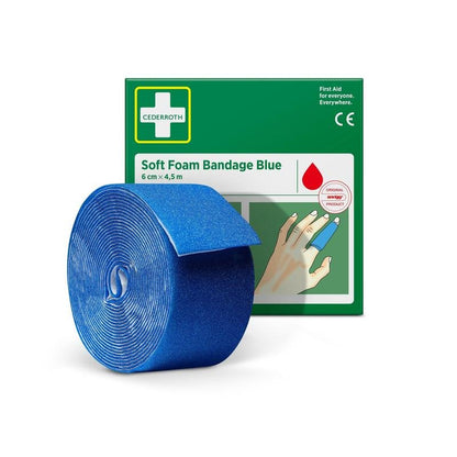 A roll of Cederroth soft foam bandage blue 6 cm x 4.5 m is pictured in front of the green-white packaging of Orkla Wound Care AB, on which the bandage is wrapped around a finger.