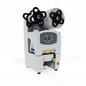 The Duni GmbH sealing machine DF5, incl. 1 cassette DF5, features two top film rolls, a digital control panel with buttons and displays, as well as an orange power button for professionally sealing beverage cups. 1 piece per package.