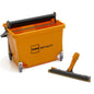 A TASKI Opti Mop 30 from Diversey (30 cm, 8 l bucket, incl. press and mop body), ideal for wet cleaning small/obstructed areas, stands next to an orange-gray floor scraper.