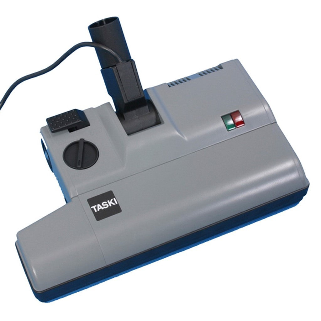 The TASKI electric vacuum brush 230V 38mm from Diversey Deutschland GmbH & Co. OHG is a gray suction head with a black nozzle, round scale, cable, and two control lights (red/green) on the top. Packaging: 1 piece. Power supply: 230V.