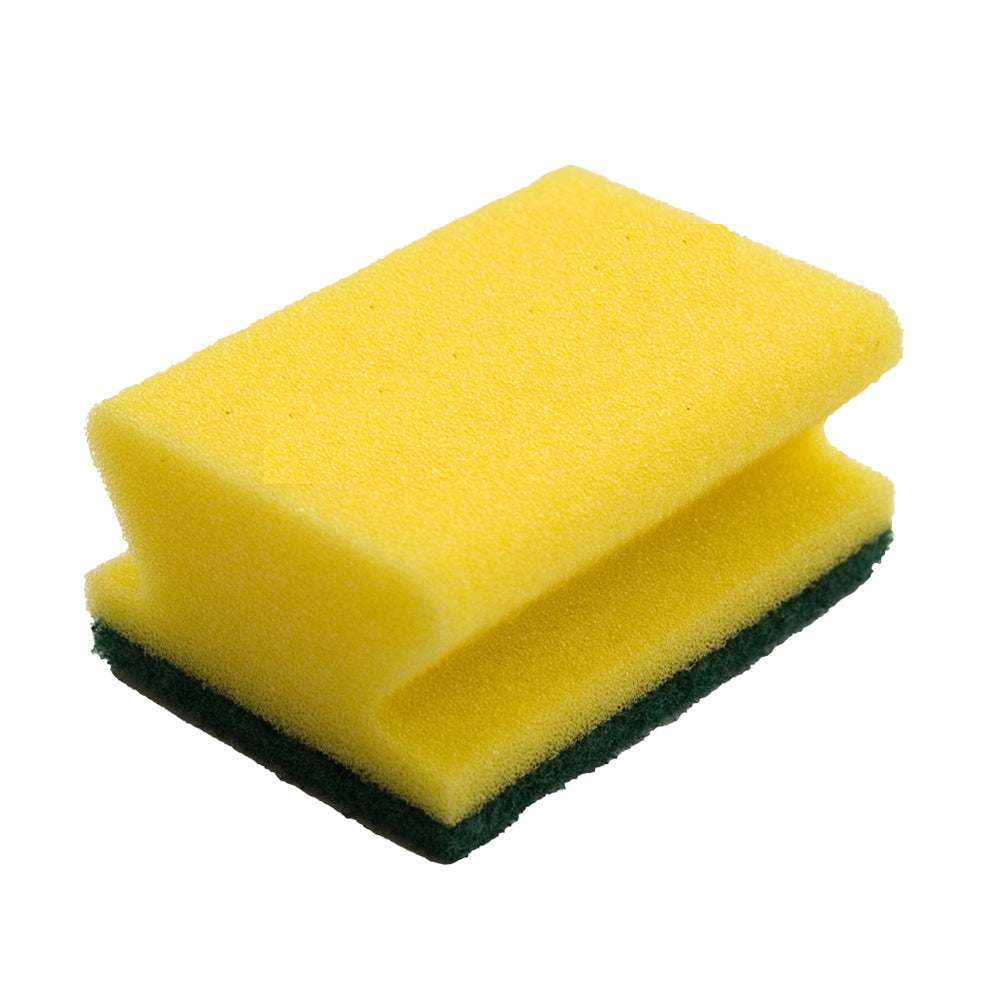 A rectangular yellow/green TASKI sponge strong and robust, 6 x 9.5 cm, with green scouring pad from Diversey Deutschland GmbH & Co. OHG for effective cleaning of heavy soiling on non-sensitive surfaces; photograph against a white background.