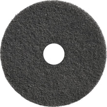 A round, black TASKI Americo Dominator Pad 17" (43 cm) from Diversey Deutschland GmbH & Co. OHG with a rough texture and center hole - an extra aggressive stripping pad, ideal for intensive floor cleaning (Package: 1 piece).