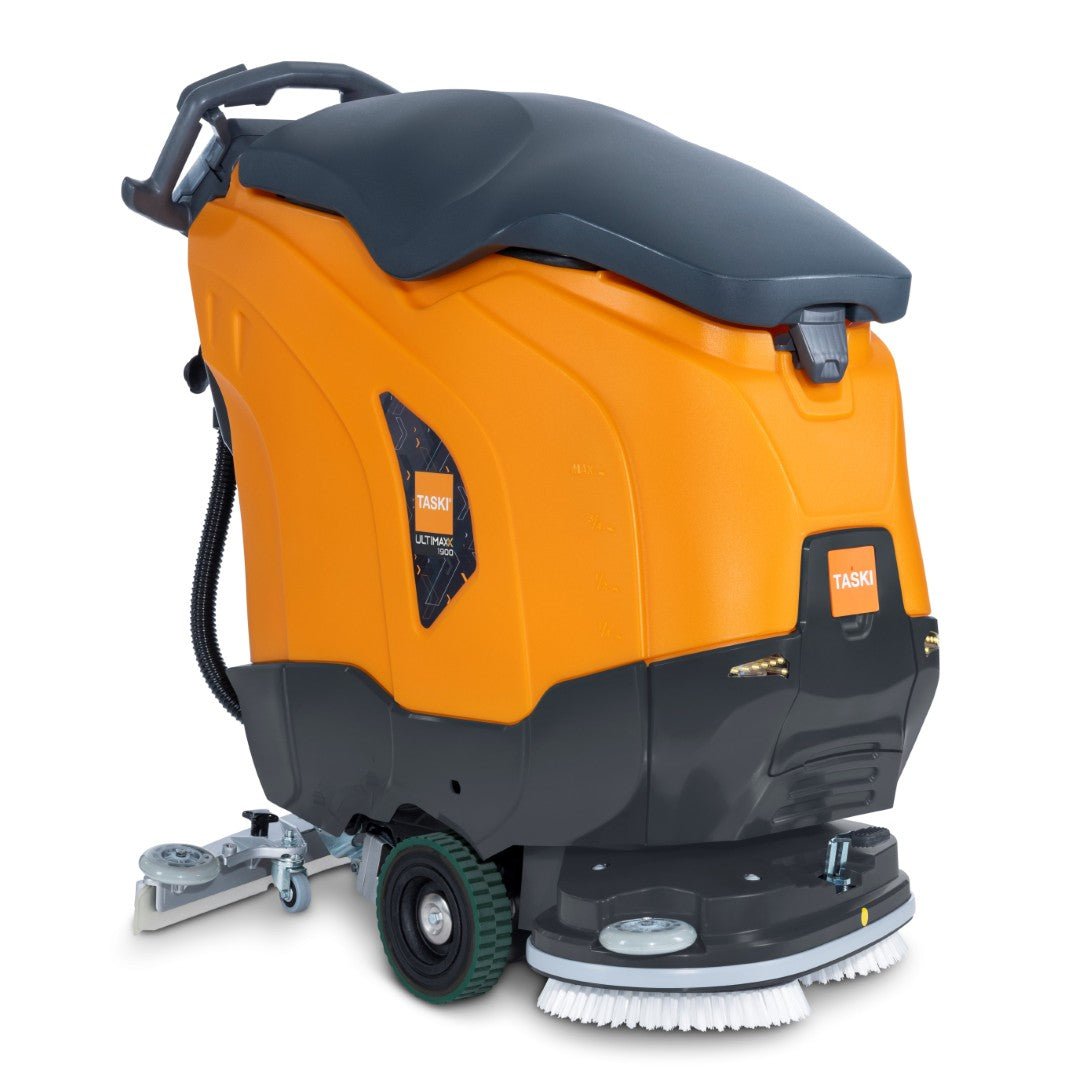 The orange-black TASKI ULTIMAXX 1900 DD65 Performance BMS 13A from Diversey Deutschland GmbH & Co. OHG features a handle, a control panel, wheels, front scrubbing brushes, a 42-liter tank, and a 65 cm long double disc for professional cleaning.