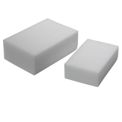 Two rectangular white sponges are visible against a plain background. The Vileda Professional Miraclean Dirt Eraser Big on the left side is larger at 12 x 7.5 x 2.8 cm, while the eco-friendly version on the right side is smaller. Both have smooth surfaces and sharp edges, ideal for removing stubborn stains.