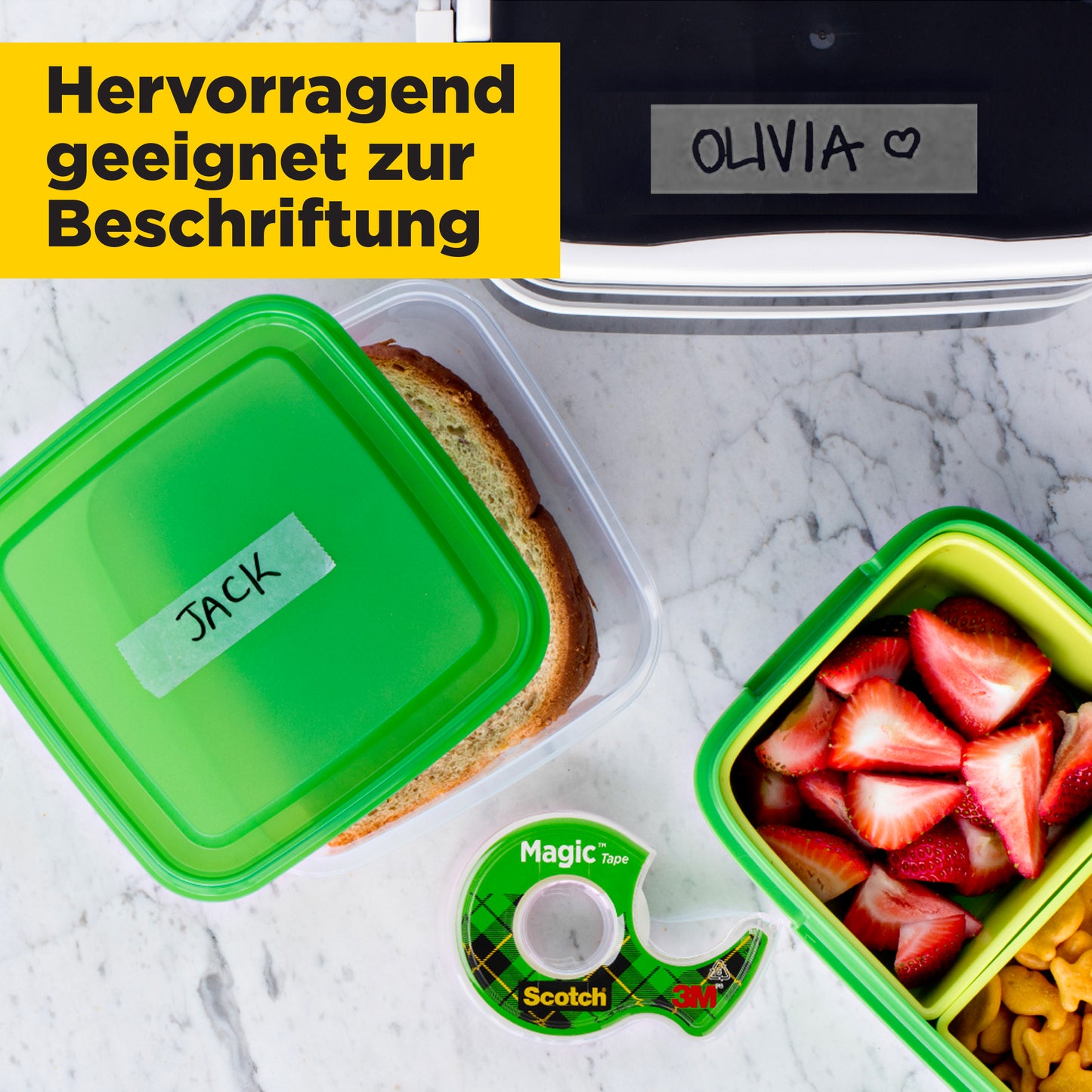 Eine Lunchszene zeigt drei Boxen (eine "JACK" mit einem Sandwich, eine mit Obst und Nüssen, eine "OLIVIA" mit einem Herz) und ein Scotch® Magic™ Unsichtbares Klebeband von 3M Deutschland GmbH. Deutscher Text: "Hervorragend geeignet zur Beschriftung.