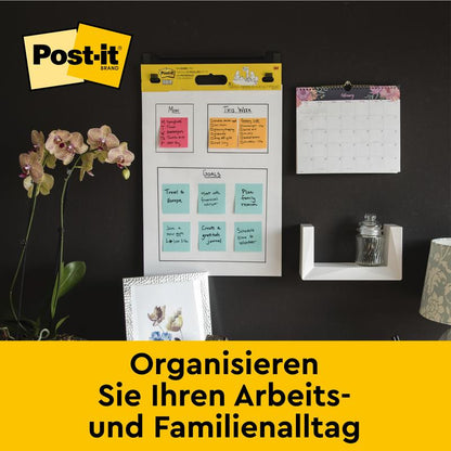 An office wall with the Post-it® Super Sticky self-adhesive Meeting Chart/Flipchart 559 from 3M Deutschland GmbH (63.5 x 76.2 cm), monthly calendar, shelf with glass, orchid, and photos. Text: "Organize your everyday life.
