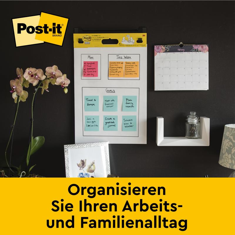 A wall organizer with Post-it® Super Sticky self-adhesive Meeting Chart/Flipchart by 3M (58.4 x 50.8 cm, 20 sheets/block, incl. Command™ strips), colored notes, and calendar facilitates the organization of work & family.