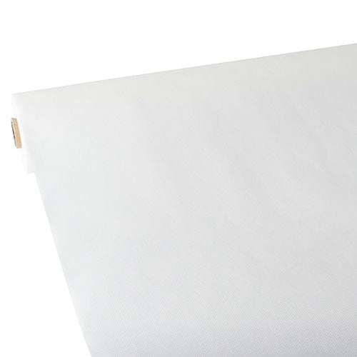 A large roll of Starpak tablecloth, fabric-like, fleece 'Soft Selection' (25 m x 1.18 m, white) is rolled out on a flat surface, with the smooth surface visible at the upward-curved edge. The Starpak roll is seen diagonally from one corner.