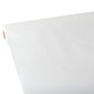 A large roll of Starpak tablecloth, fabric-like, fleece 'Soft Selection' (25 m x 1.18 m, white) is rolled out on a flat surface, with the smooth surface visible at the upward-curved edge. The Starpak roll is seen diagonally from one corner.