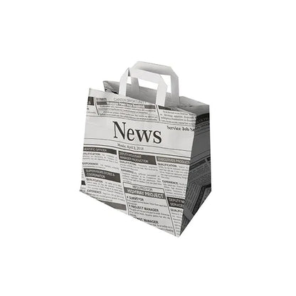 The PAPSTAR 50 carrier bags from PAPSTAR GmbH are eco-friendly paper bags with handles, featuring a black-and-white newspaper motif with headlines and articles on a white background.