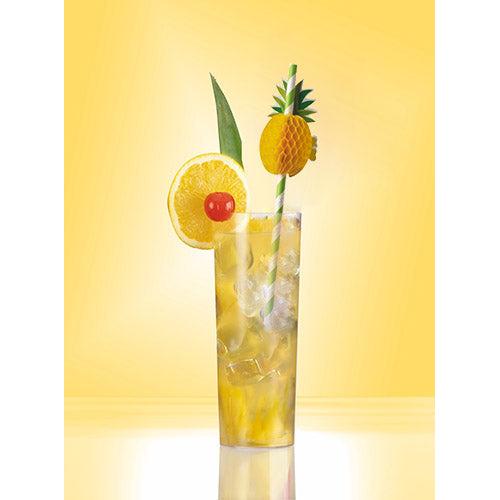 A tall glass with a yellow iced drink, garnished with lemon, cherry, green leaf, and a small pineapple, is adorned by a PAPSTAR 50 straws paper from PAPSTAR GmbH. The solid yellow background enhances the refreshing appeal.