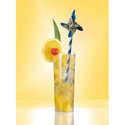 A tall glass with a chilled yellow drink, garnished with lemon, cherry, pineapple leaf, and a PAPSTAR 50 straws paper straw (Ø 6 mm · 20 cm, from PAPSTAR GmbH) with a pinwheel against a yellow background.