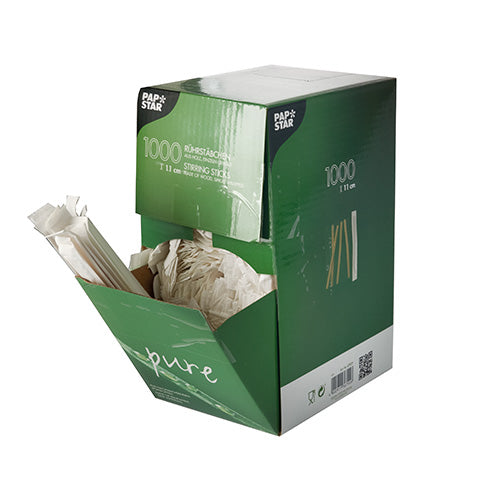 A green-white box from PAPSTAR GmbH with the inscription "1000 wooden stir sticks, "pure", individually wrapped" shows several wooden stir sticks protruding from the open front side.