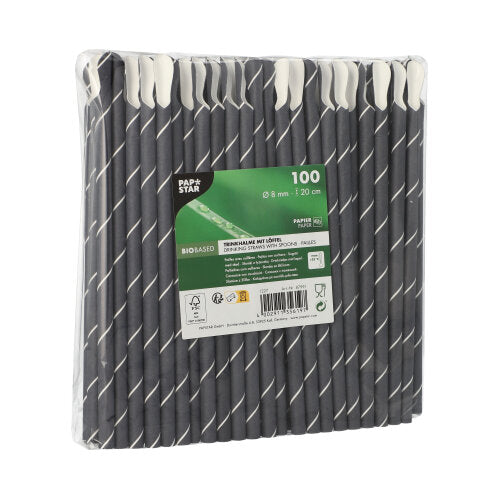 A transparent plastic packaging contains 100 black paper straws with spoon ends from PAPSTAR GmbH, 8 mm diameter, 20 cm long. The front label features the brand name, product details, and environmental certifications for straws.