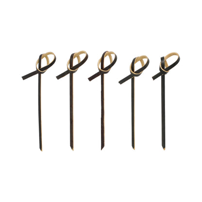 Five PAPSTAR 250 finger food picks from PAPSTAR GmbH in black with light brown bow accents at the top, arranged in a row on a white background.