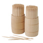 Two PAPSTAR wooden toothpicks "pure", round, 6.8 cm, are presented upright in wooden dispensers with toothpicks inside and three loose ones on a white surface. Each bag holds up to 400 pieces. Brand: PAPSTAR GmbH. Background: solid white.