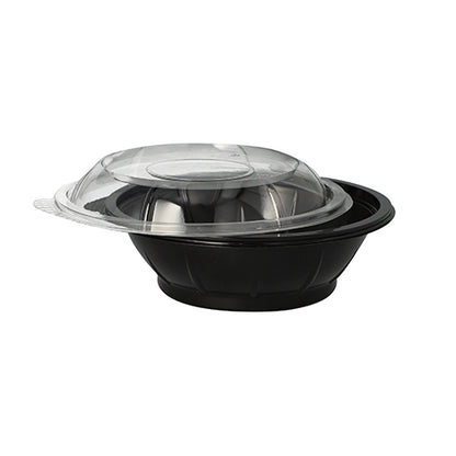 On a plain white background, a black Starpak salad bowl made of PET (600 ml) with a clear, domed 'Snap It' R-PET lid is depicted, slightly tilted.