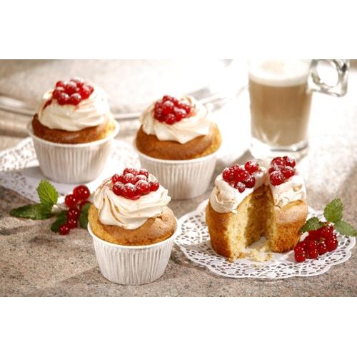 Four muffins in white PAPSTAR muffin baking cups Ø 5 cm, 3.2 cm high (foil) from PAPSTAR GmbH are topped with white icing and red berries on stone. One muffin baking cup is halved to show the interior; mint and coffee appear in the background.