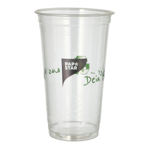 A clear PLA cup "Cup made of corn" from PAPSTAR GmbH with green text stands upright and empty against a white background. This eco-friendly drinking cup is biodegradable.