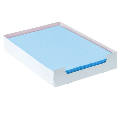 A neatly arranged stack of blue AMPri Dental crepe cover tray filter papers 18 x 28 cm is presented in a white cardboard tray with open sides. This rectangular tray keeps the paper perfectly aligned and minimalist, ideal for organized dental care routines, provided by AMPri Handelsgesellschaft mbH.