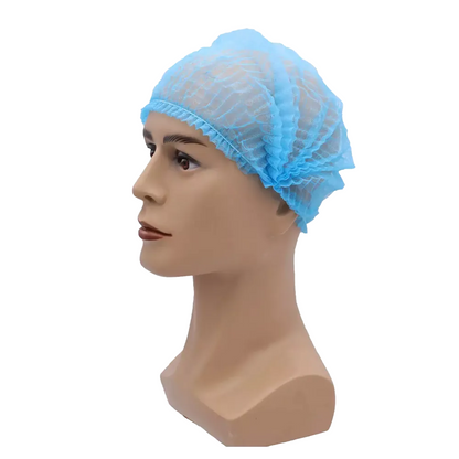 A mannequin head is wearing a blue AMPri MED-COMFORT clip cap 52 cm, from AMPri Handelsgesellschaft mbH. The hairnet made of lightweight polypropylene with elastic edges fits snugly around the head of the mannequin and provides hygienic protection. The image is set against a plain white background.