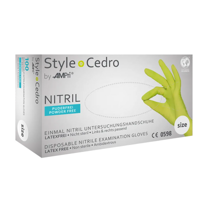 Box AMPri STYLE CEDRO nitrile gloves powder-free by MED-COMFORT, green disposable examination gloves made of nitrile, size medium, latex-free, non-sterile, ambidextrous, and powder-free. The box shows a gloved hand with an 'OK' sign and product details in German (nitrile gloves powder-free) and English.