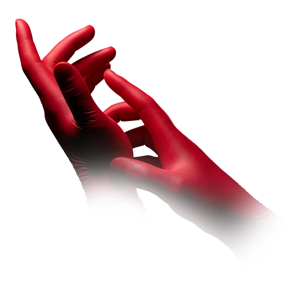 A pair of hands covered with red AMPri STYLE HOT CHILI nitrile gloves powder-free by MED-COMFORT from AMPri Handelsgesellschaft mbH. The hands are positioned with fingers slightly curved and touching, and the image gradually fades out at the wrists, making it partially transparent at the base. The background is white.