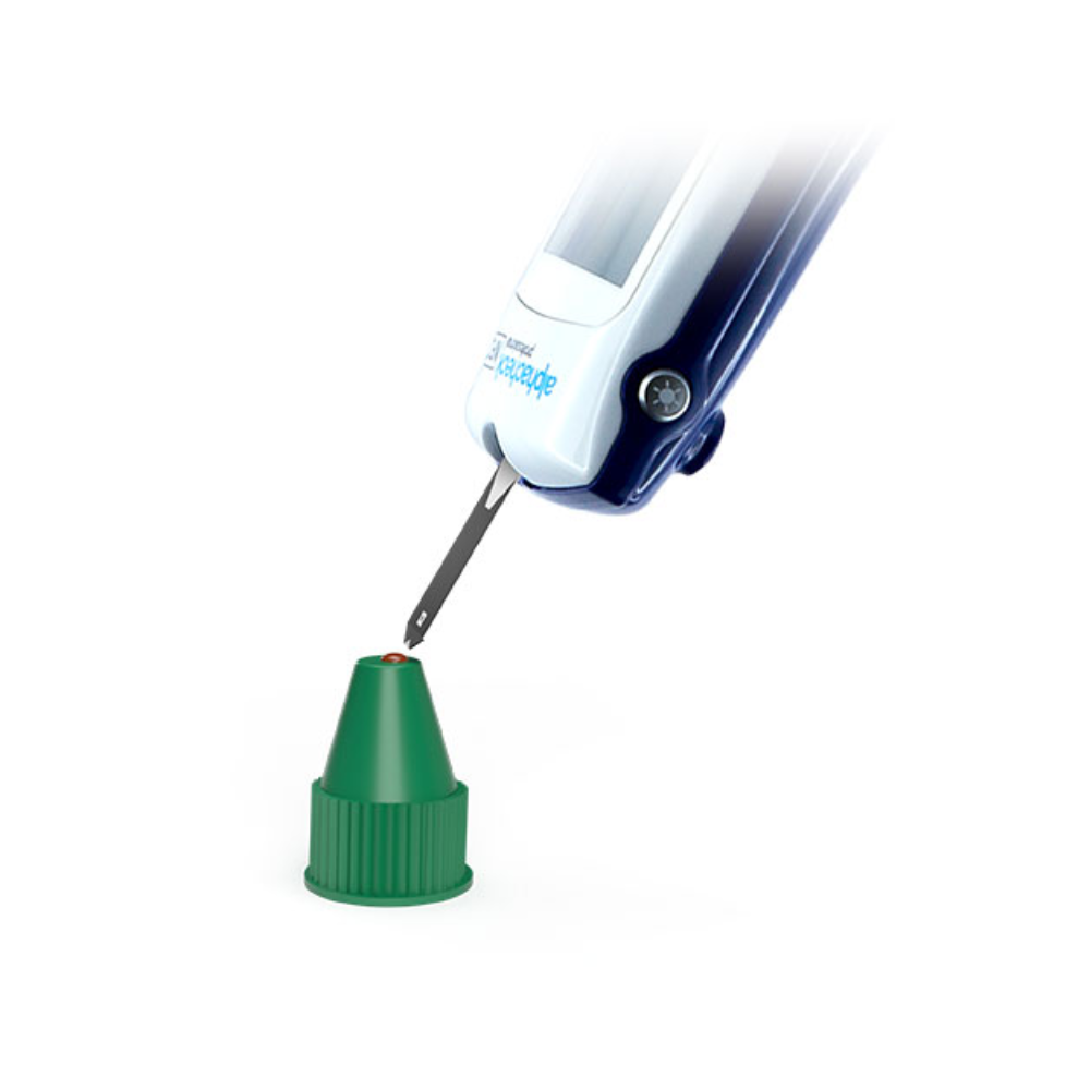 The image shows a close-up of a medical device with a lancet extended toward a small green cap on a white background. The device branded "Berger Med GmbH" appears to be used for pricking in blood glucose monitoring and resembles an Alphacheck Professional Control Solution A+ B | Package (2 bottles).