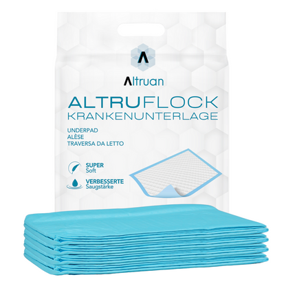 A package of Altruan Altruflock® bed protection pads 60 x 90cm Supersoft Extremely Absorbent | Package (25 pieces) is displayed. The packaging reads “hospital pad” and shows an image of an unfolded hospital pad. The product is characterized by the features “Super Soft” and “Improved Absorbency”. Several blue bed protection pads lie in front of the package.