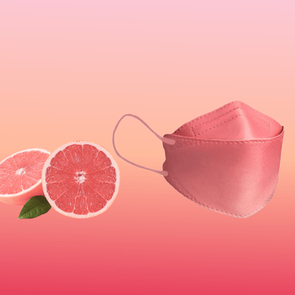 A particle-filtering Altruan designer face mask (FFP2 standard) is elegantly positioned next to two grapefruit halves on a pink gradient background, highlighting its stylish design and ergonomic fit.