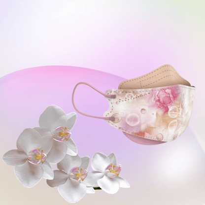 A particle-filtering Altruan designer face mask that meets the FFP2 standard shows its ergonomic fit against a pastel background with a pink-green gradient. In the foreground, a cluster of white orchids highlights the elegance of its stylish design.